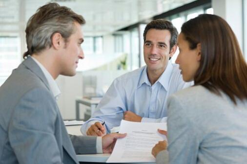 Couple discussing contract while meeting with businessman